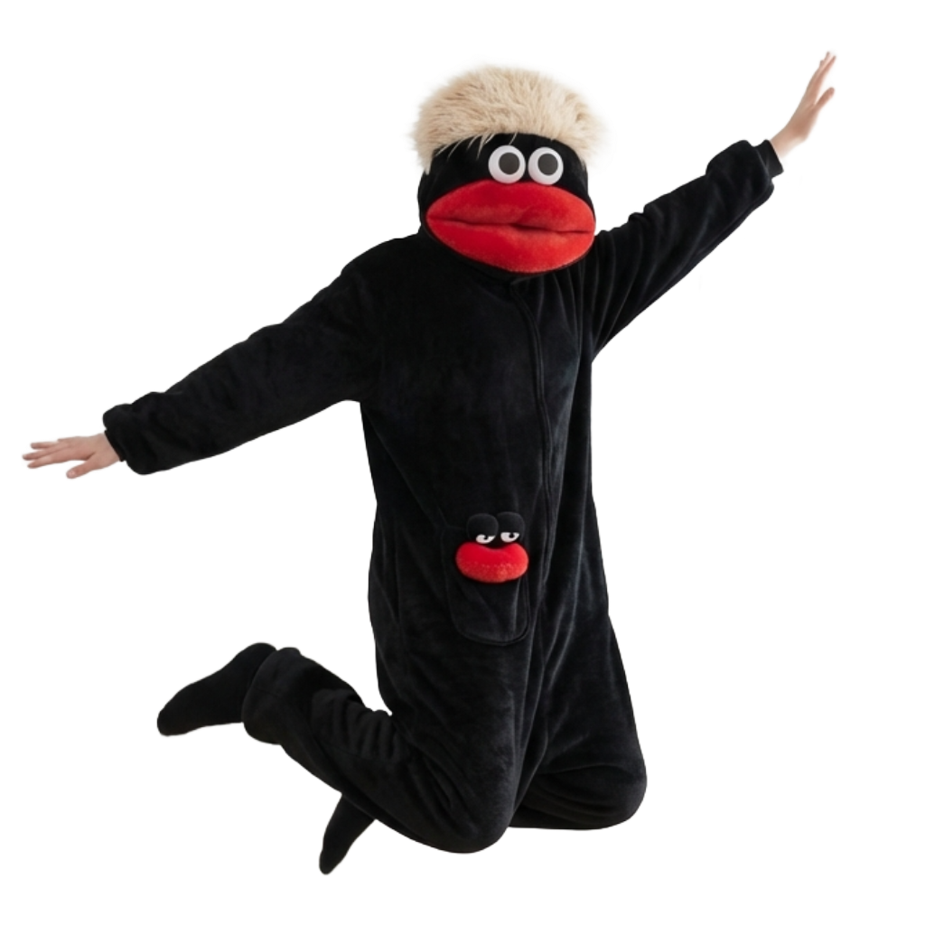 Person wearing a black glimbo onesie with a red mouth and white eyes on a white background